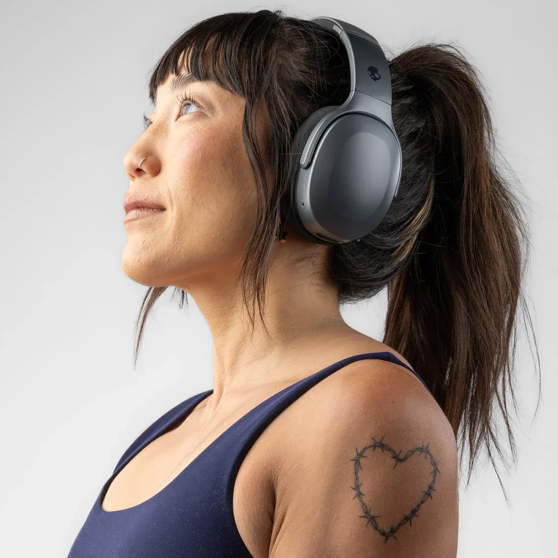 Person wearing Skullcandy Crusher headphones